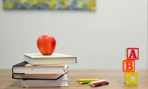 Books stacked with apple on top